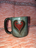 greenish mug with red heart on it.